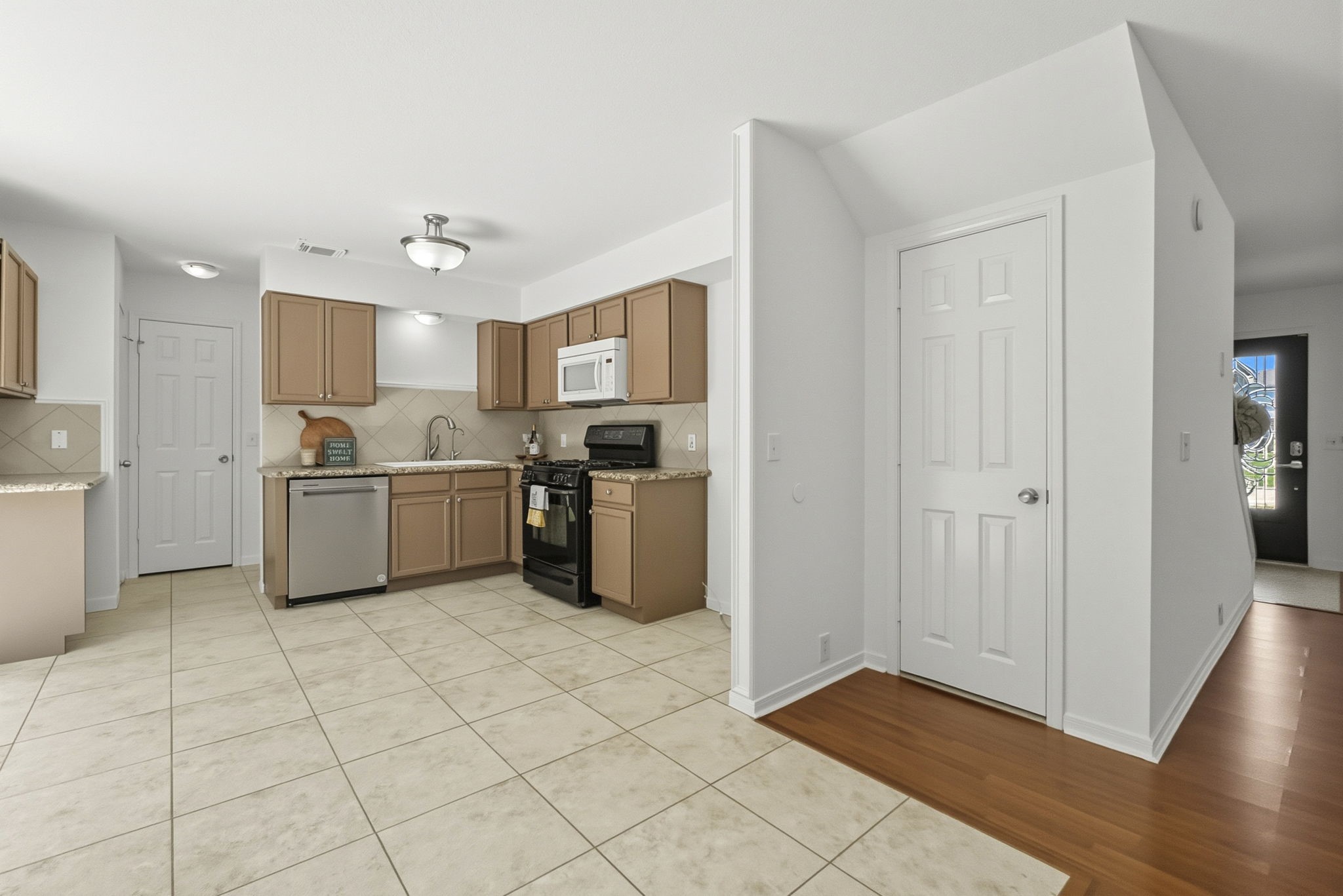 11907 Ezekiel Road Tomball, TX 77375 - Photo 10 of 39 a kitchen with stainless steel appliances a refrigerator sink and cabinets