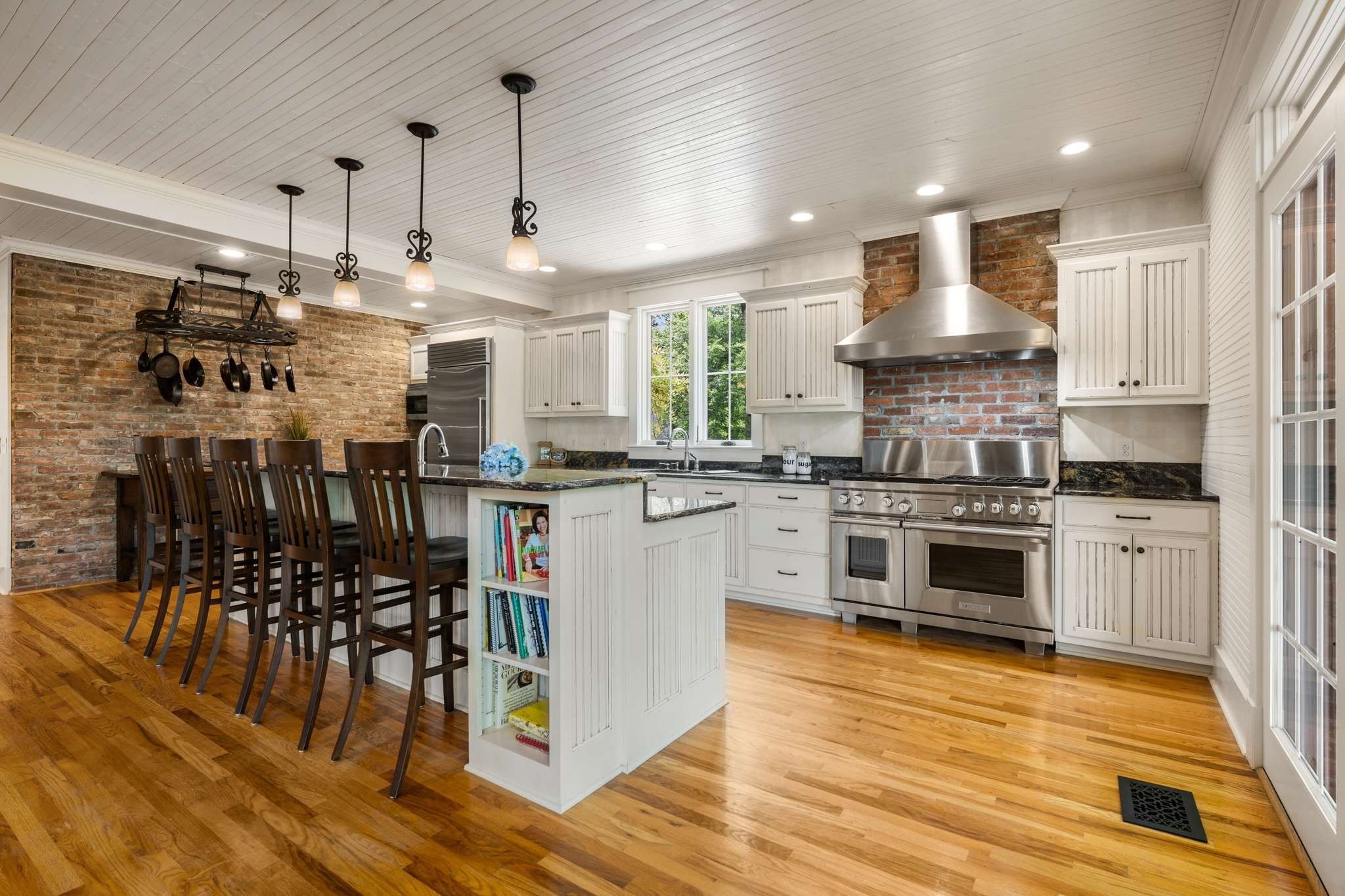 405 Webb Road West Bell Buckle, TN 37020 - Photo 14 of 70 a kitchen with kitchen island granite countertop a sink cabinets and wooden floor
