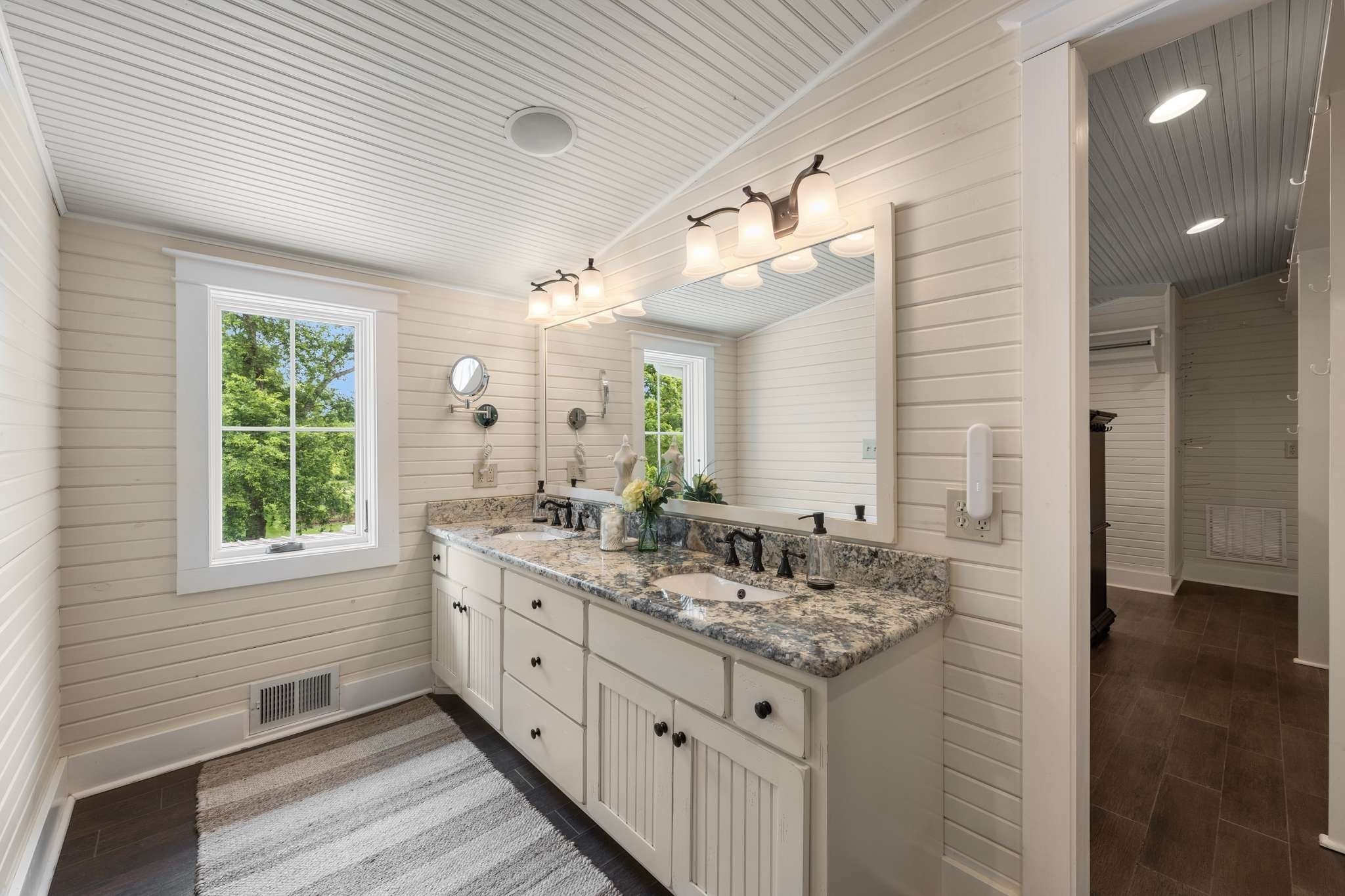 405 Webb Road West Bell Buckle, TN 37020 - Photo 28 of 70 a bathroom with a granite countertop sink a large mirror and a shower