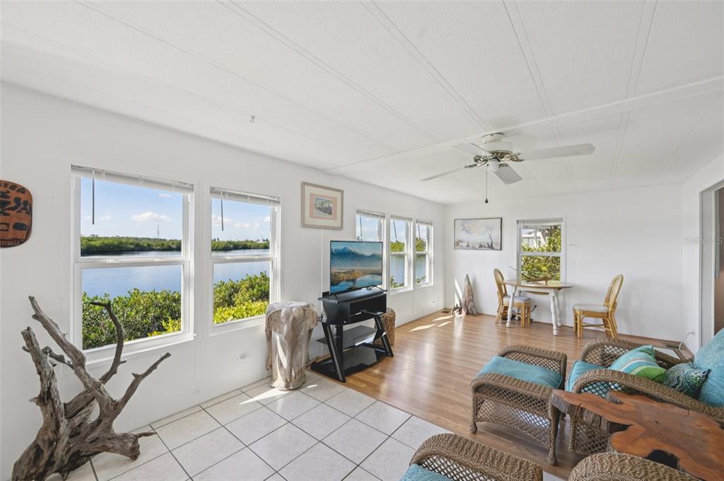 156 Martinique Road North Port, FL 34287 - Photo 14 of 46 a living room with fireplace furniture and a floor to ceiling window