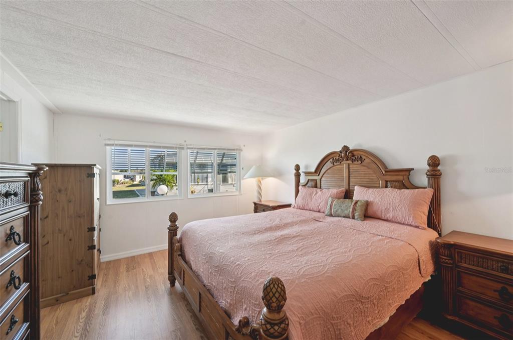 156 Martinique Road North Port, FL 34287 - Photo 18 of 46 a bedroom with bed and wooden floor