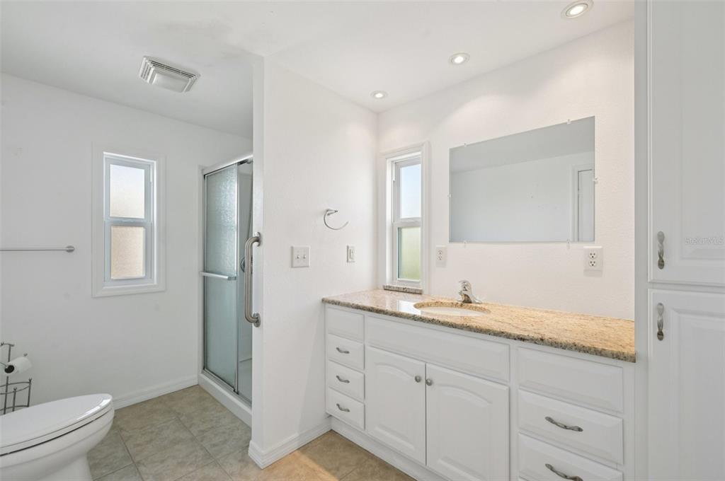 156 Martinique Road North Port, FL 34287 - Photo 20 of 46 a spacious bathroom with a granite countertop sink a toilet and a mirror