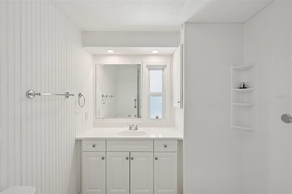 156 Martinique Road North Port, FL 34287 - Photo 22 of 46 a bathroom with a sink a mirror and a shower