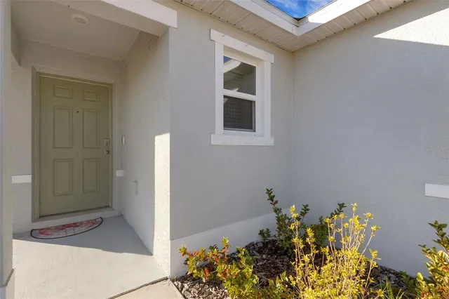 a view of a big room with wooden floor and a window