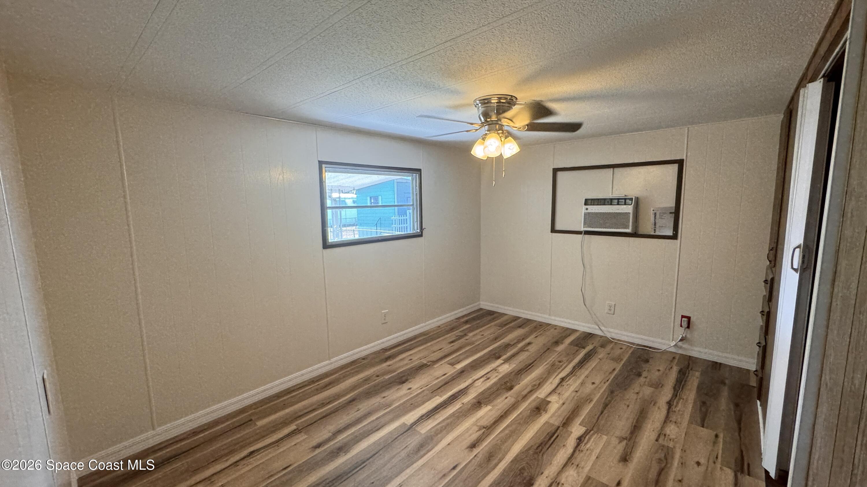 2522 Amberly Road Northeast Palm Bay, FL 32905 - Photo 8 of 13 wooden floor in an empty room with a window