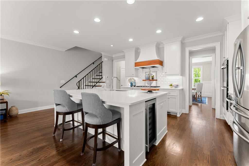 3206 Ridge Towne Place Duluth, GA 30096 - Photo 7 of 42 a kitchen with stainless steel appliances granite countertop a kitchen island a hardwood floor and a sink