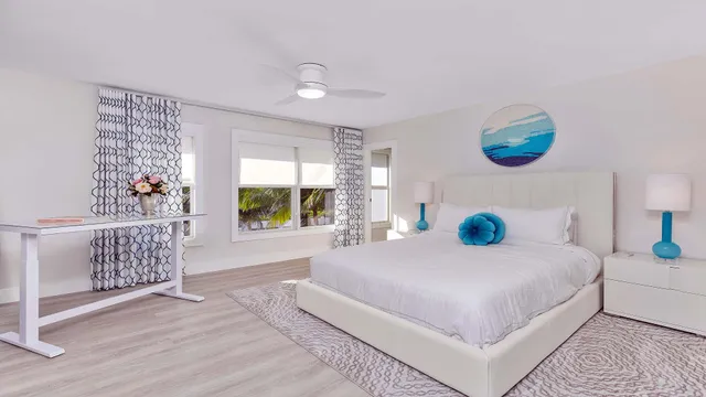 a bedroom with a large bed and a window