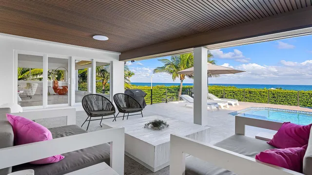 a living room with furniture and a floor to ceiling window