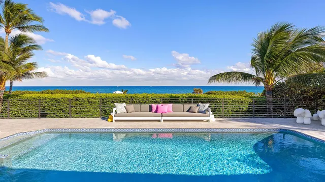 a view of a swimming pool with an outdoor seating