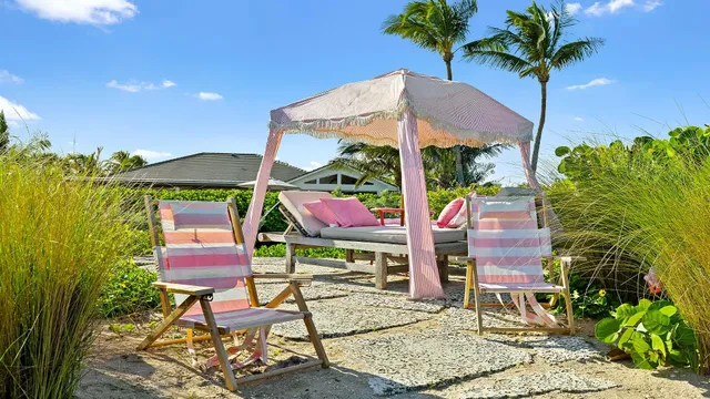 a group of tables and chairs sitting in patio of a house