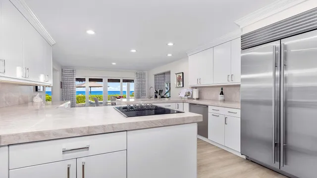 a kitchen with stainless steel appliances a sink and a refrigerator