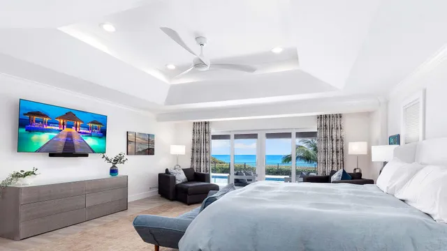 a bedroom with furniture and a large window