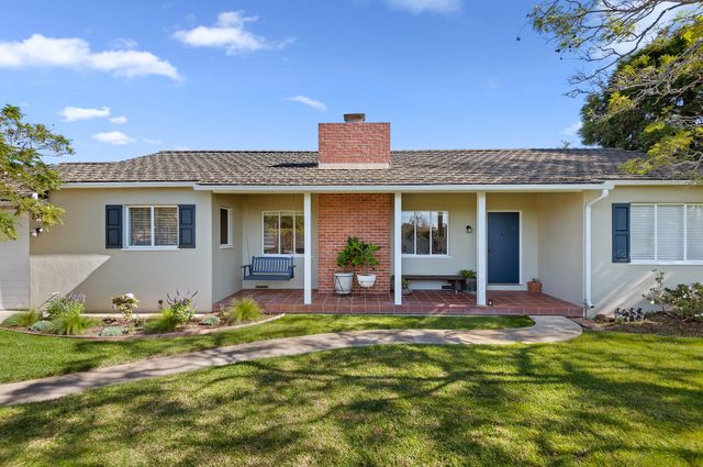 a view of a house with backyard sitting area and garden