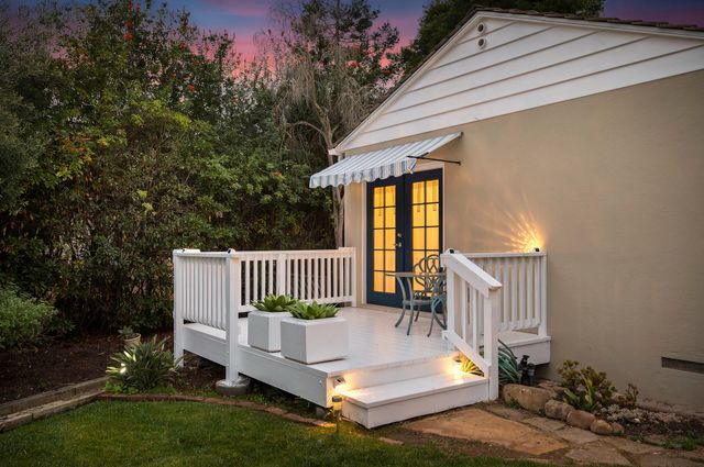 a view of a house with swimming pool and sitting area