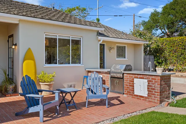 a view of a house with swimming pool and sitting area