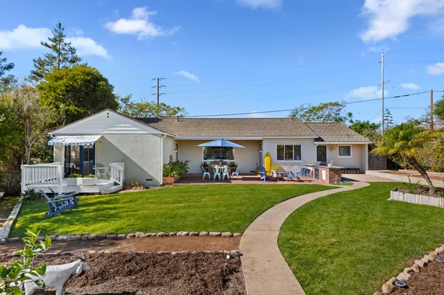 a front view of a house with swimming pool having outdoor seating