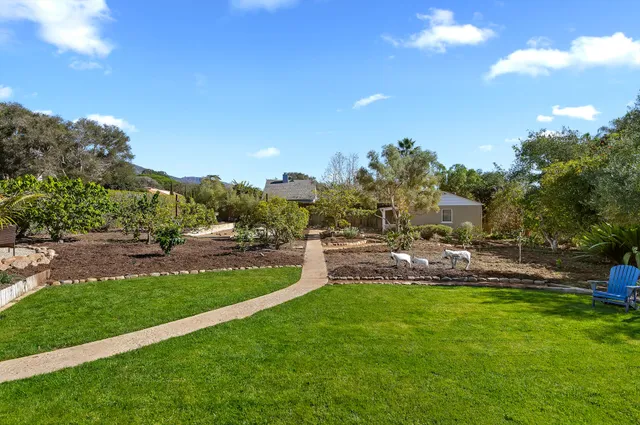 a view of yard with swimming pool and green space