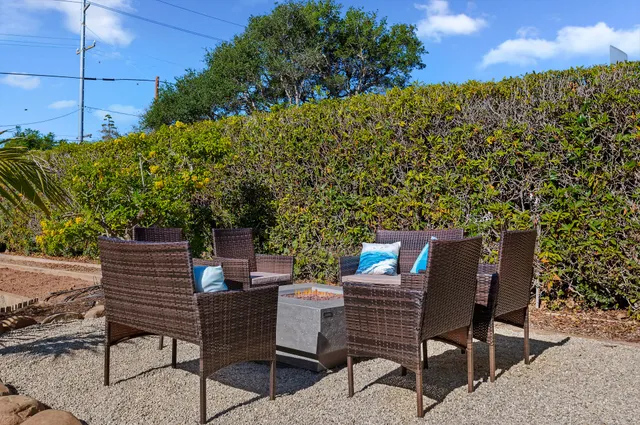 a backyard of a house with table and chairs
