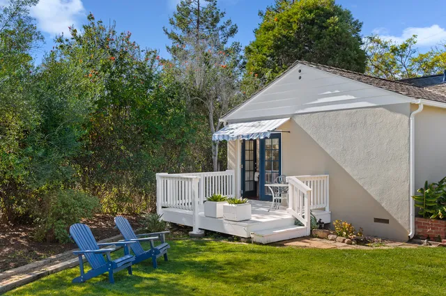a house view with a sitting space and garden