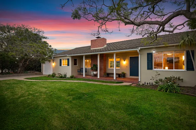 a view of a house with a yard porch and sitting area