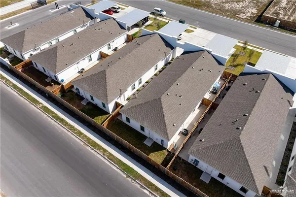 an aerial view of residential houses with outdoor space