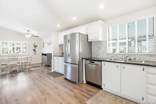 a kitchen with stainless steel appliances granite countertop a refrigerator and a sink
