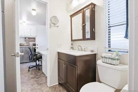 a en suite bathroom with a sink a mirror and a shower