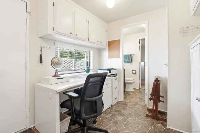 a kitchen that has a sink a stove and chairs