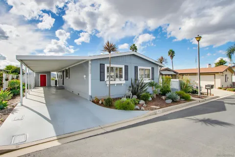 a front view of a house with plants