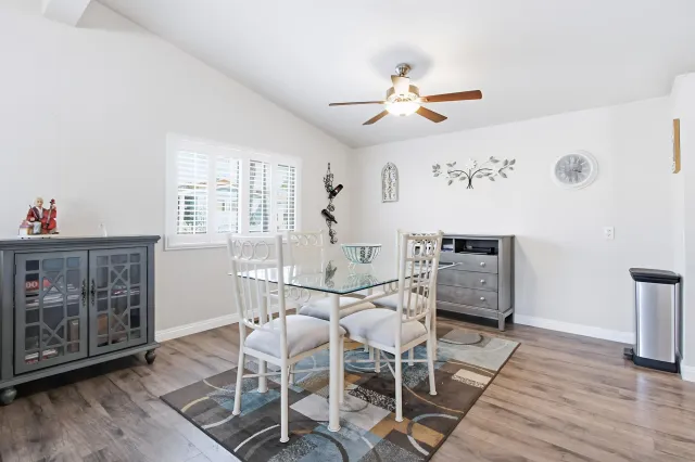 a view of a dining room with furniture and wooden floor