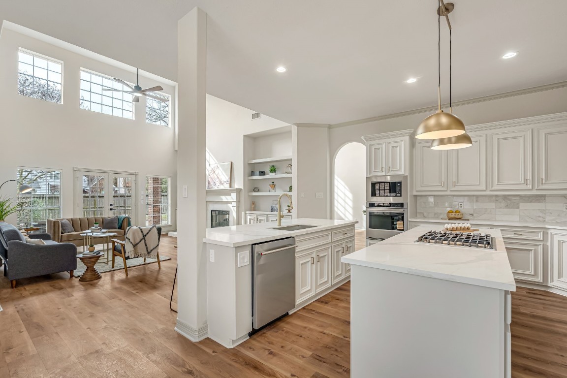 a kitchen that has a lot of cabinets in it and wooden floor