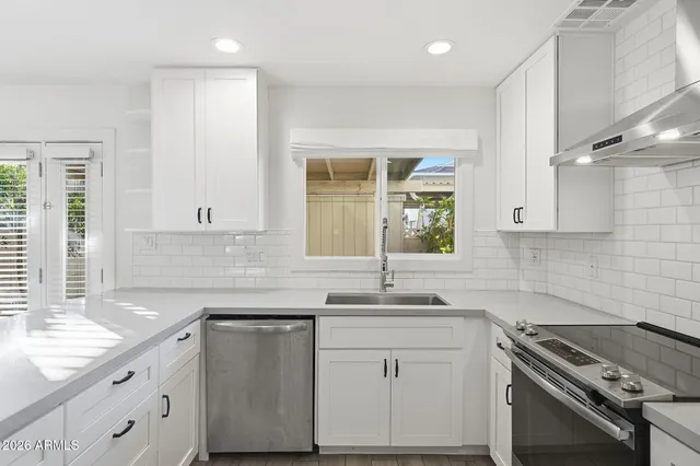 a kitchen with a sink stove and cabinets