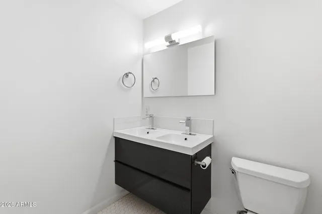 a bathroom with a toilet a sink and mirror