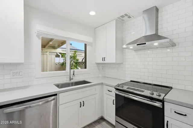 a kitchen with a stove and a sink