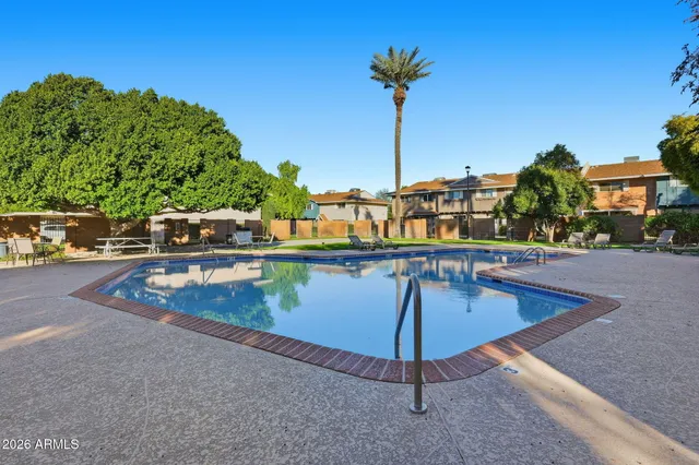 a view of a swimming pool with a chair and tables
