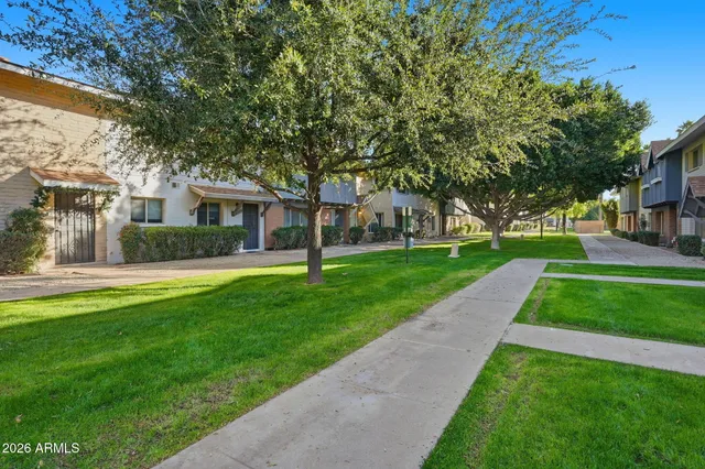 a front view of house with yard and green space