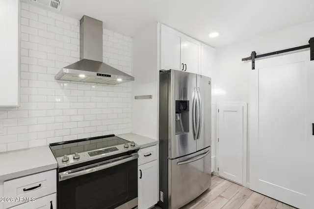 a kitchen with stainless steel appliances a refrigerator and a stove