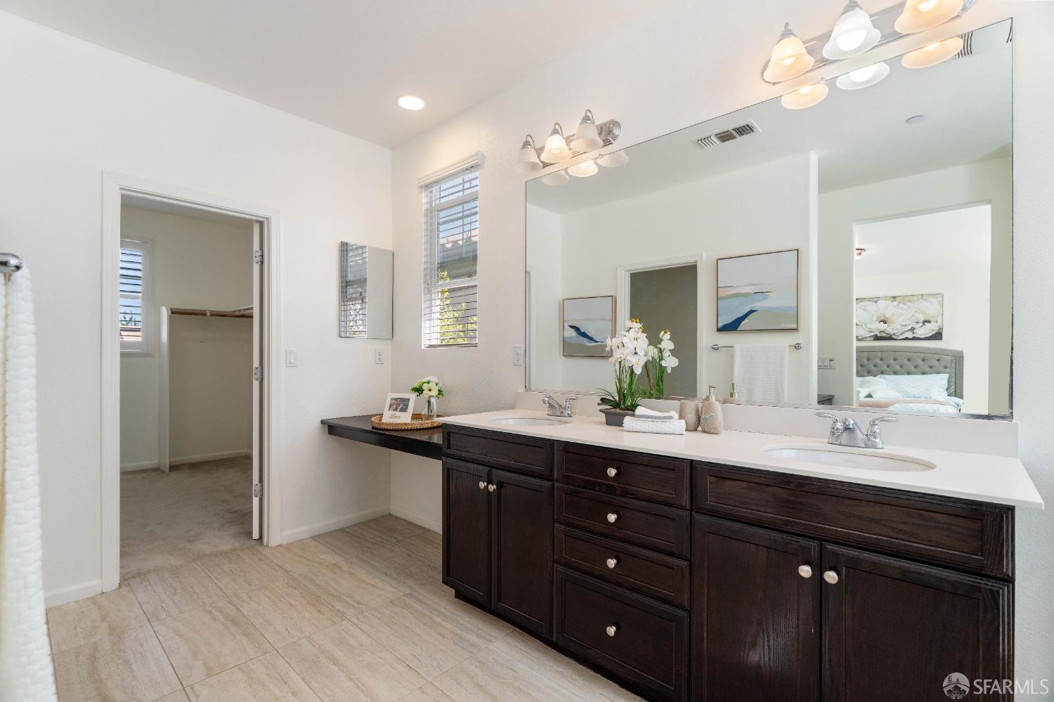 324 MacArthur Way Brentwood, CA 94513 - Photo 32 of 45 a bathroom with a sink double vanity granite and a mirror