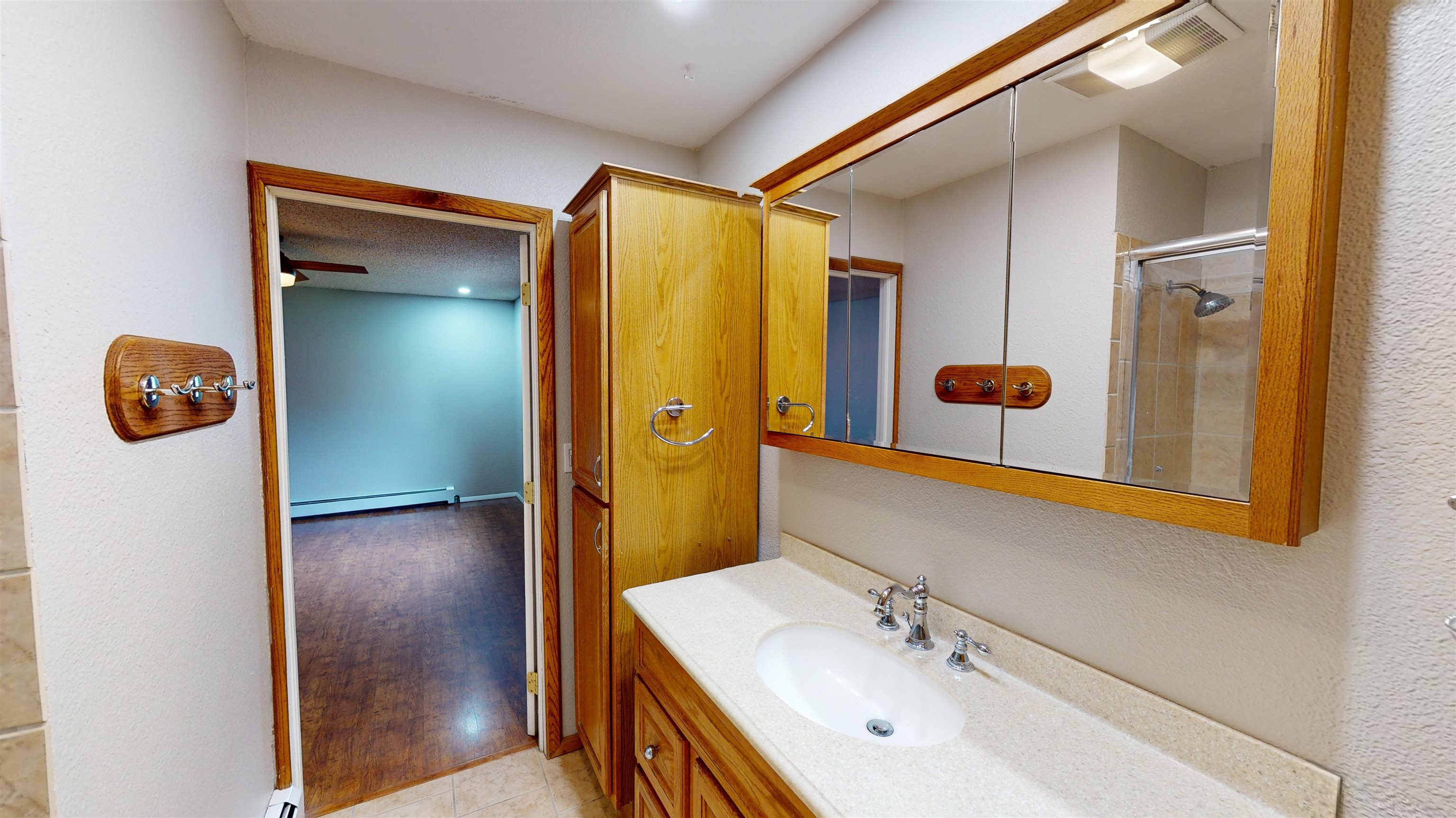 449 Doris Road Grand Junction, CO 81504 - Photo 18 of 35 a bathroom with a sink a mirror and shower