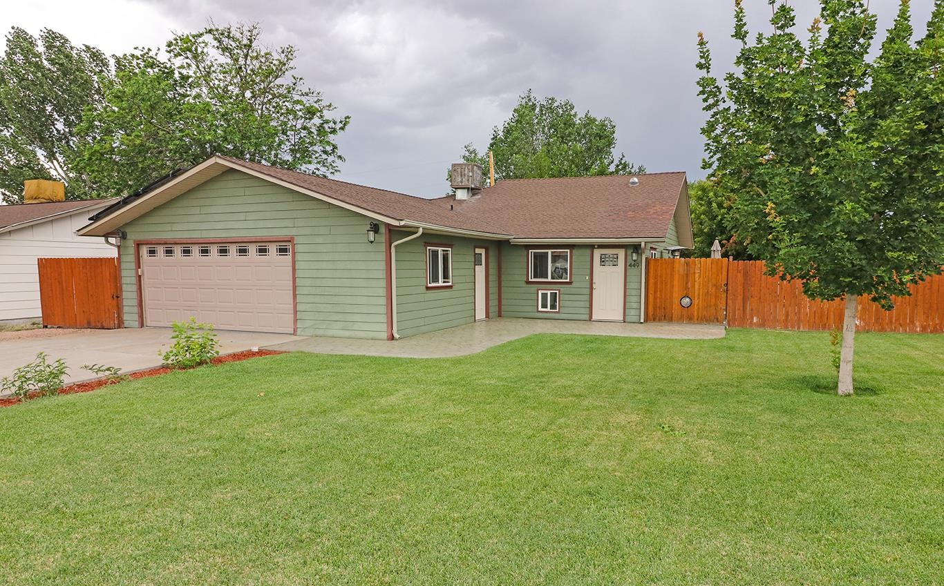 449 Doris Road Grand Junction, CO 81504 - Photo 2 of 35 a view of a yard in front of a house with plants and large tree