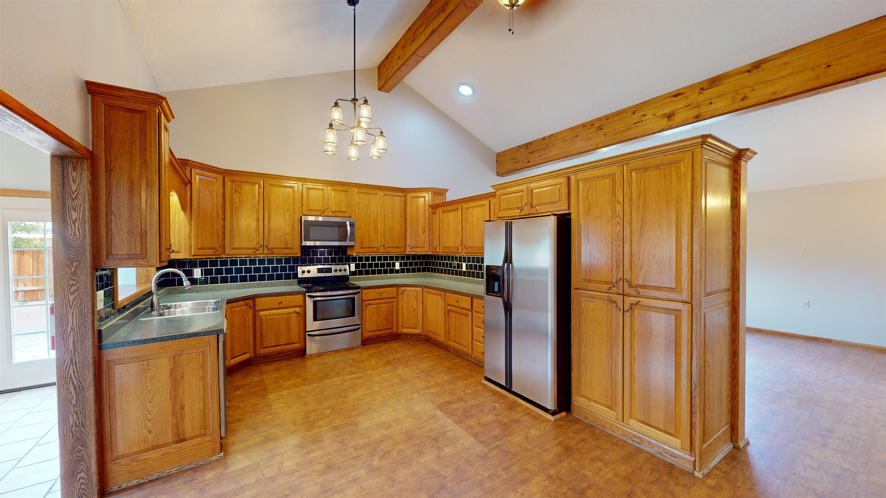 449 Doris Road Grand Junction, CO 81504 - Photo 7 of 35 a kitchen with stainless steel appliances granite countertop a refrigerator and a stove