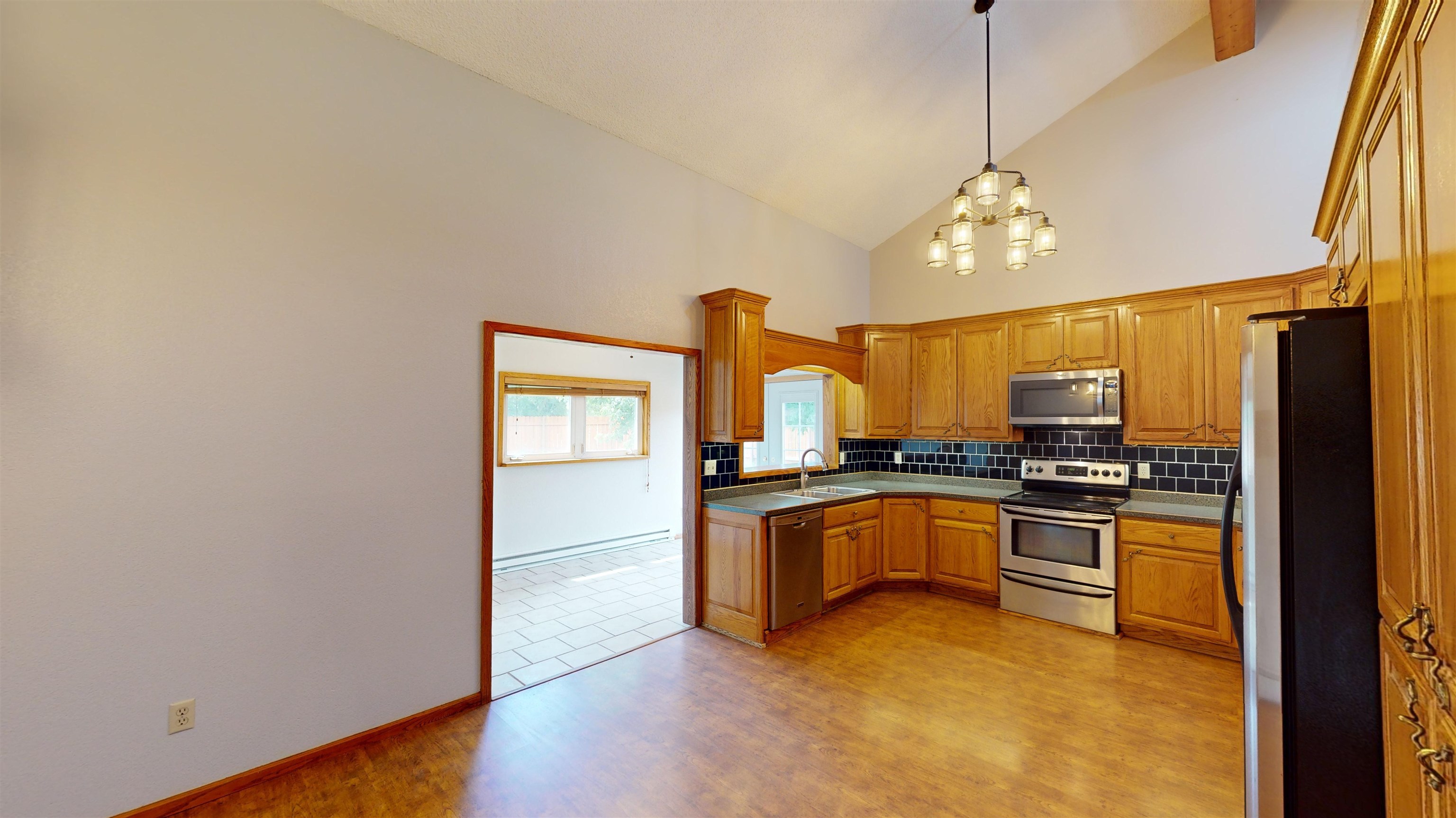 449 Doris Road Grand Junction, CO 81504 - Photo 8 of 35 a kitchen with stainless steel appliances granite countertop a stove and a refrigerator