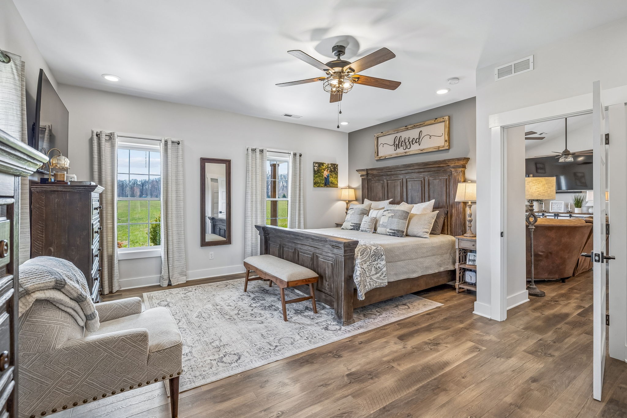1869 Taurus Farm Road Lafayette, TN 37083 - Photo 29 of 60 a bedroom with a bed a couch and a chandelier