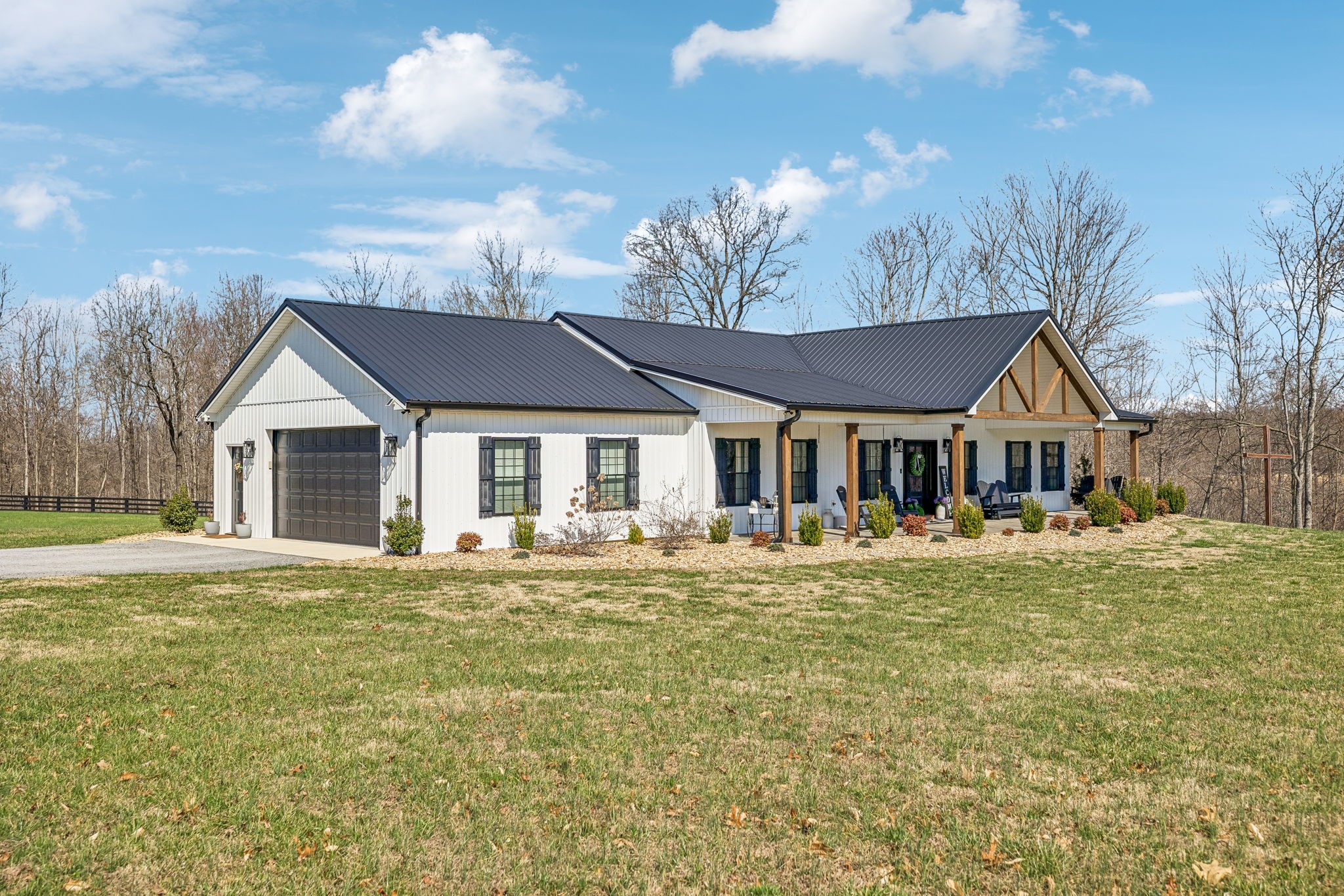 1869 Taurus Farm Road Lafayette, TN 37083 - Photo 3 of 60 a front view of a house with a garden and trees