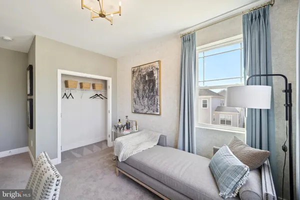 a bedroom with a bed couch and a window