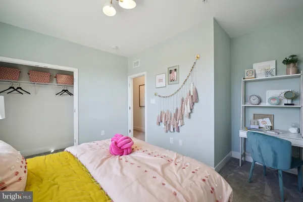 a bedroom with a bed and a dresser