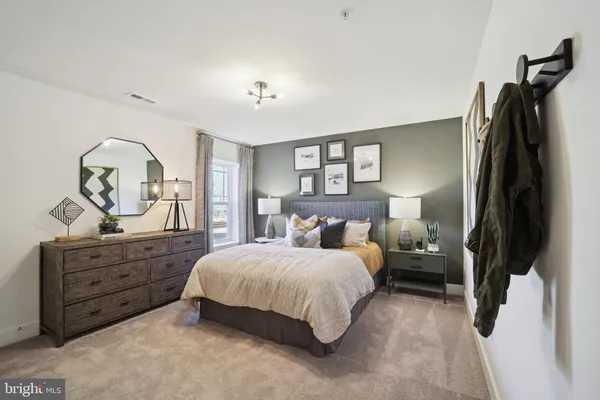 a bedroom with a bed and a dresser