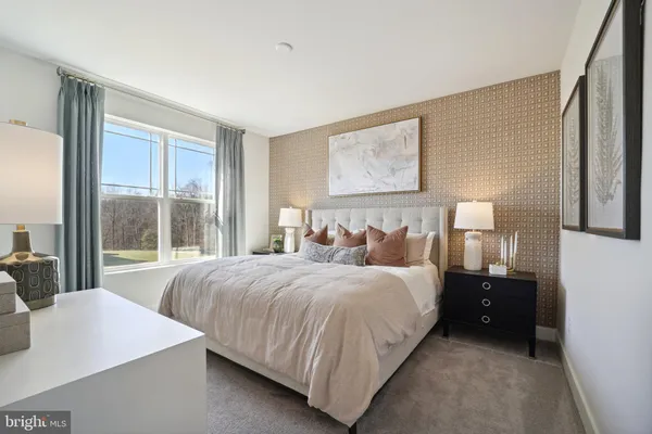 a bedroom with a bed and a large window