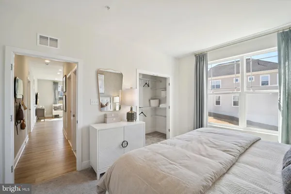 a bedroom with a bed and a large mirror