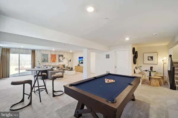 a room with furniture pool table and windows